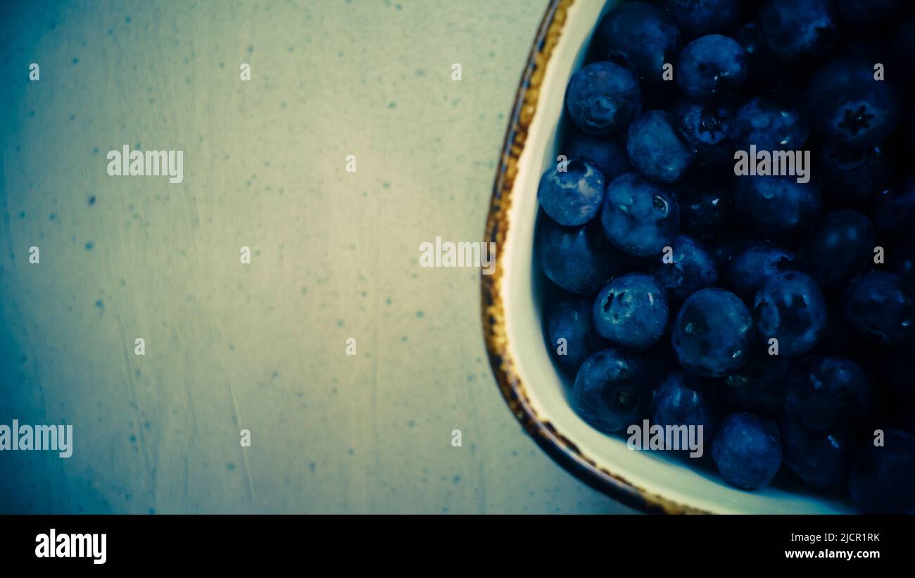 fresh organic blueberries sweet wholesome rustic on wooden table in farm close up top view Stock Photo
