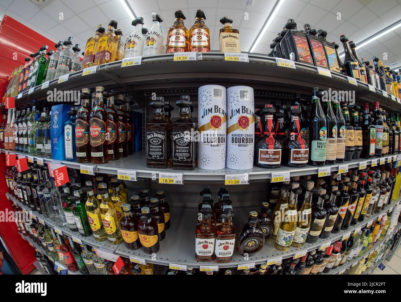 Fossano, Italy - June 07, 2022: Shelves with bottles of Whisky, rum and liqueurs with RFID hard tag - Shoplifting and anti-theft system in italian sup Stock Photo
