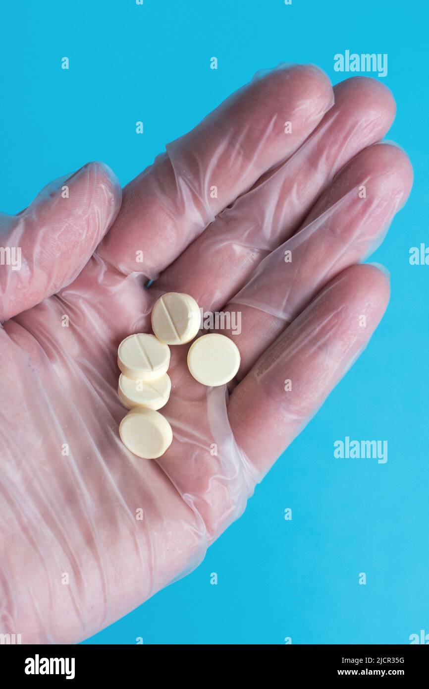 medical tablets close on the blue background. Coronavirus, flu ...