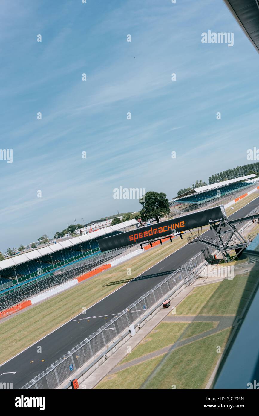 VIP View from Silverstone Wing balcony: Hamilton Straight, starting grid, lights gantry & empty spectator stands. Silverstone Circuit, Speedmachine Stock Photo