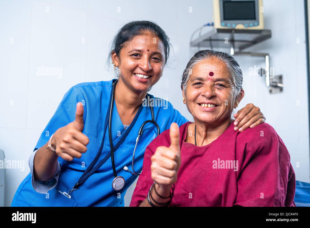 Happy smiling nurse and senior patient showing thumbs up by looking at camera at hospital - concept of successful, treatment and bonding Stock Photo