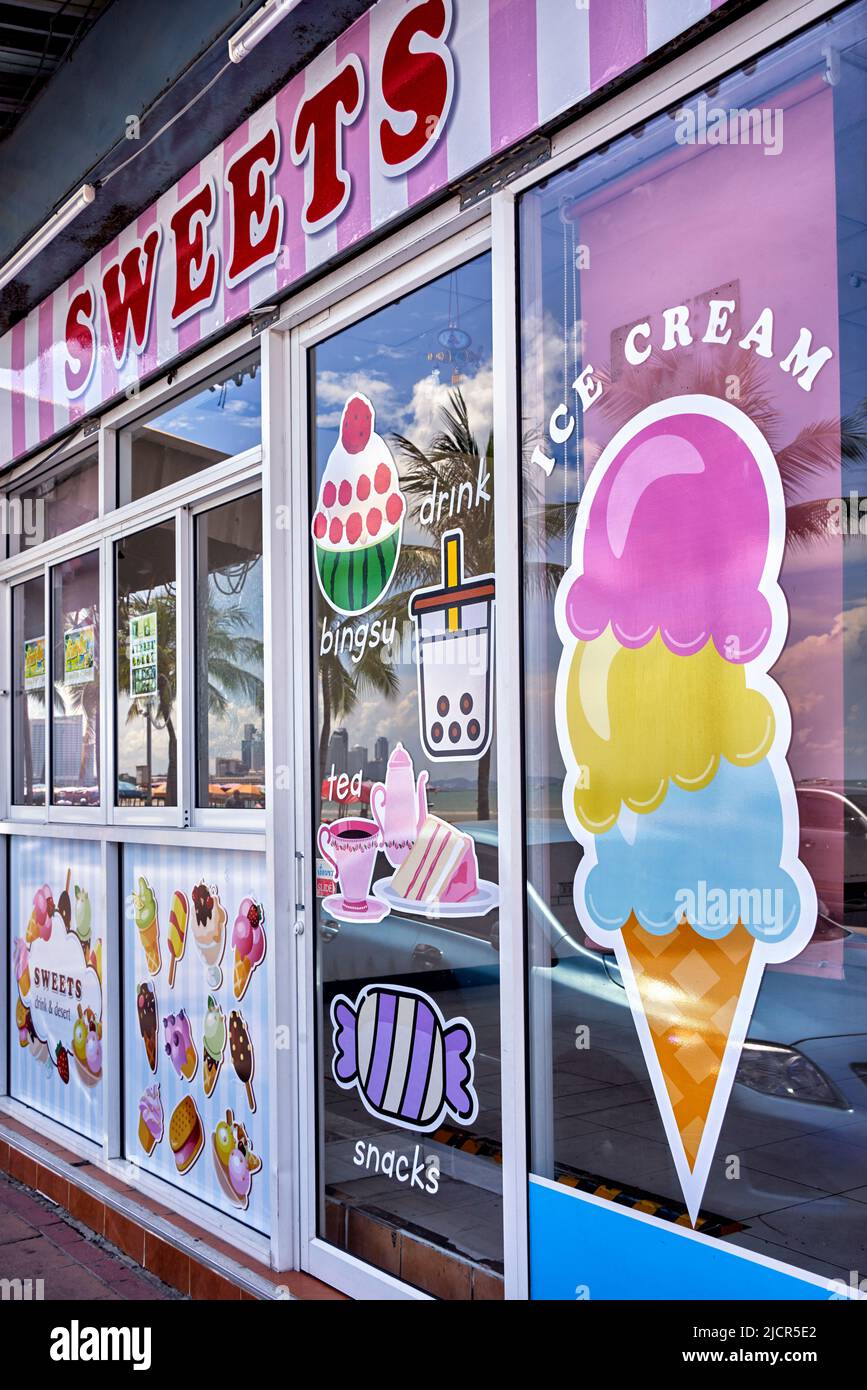 Ice cream shop window and sweets confectionery shop front exterior with  colorful window decoration Stock Photo - Alamy