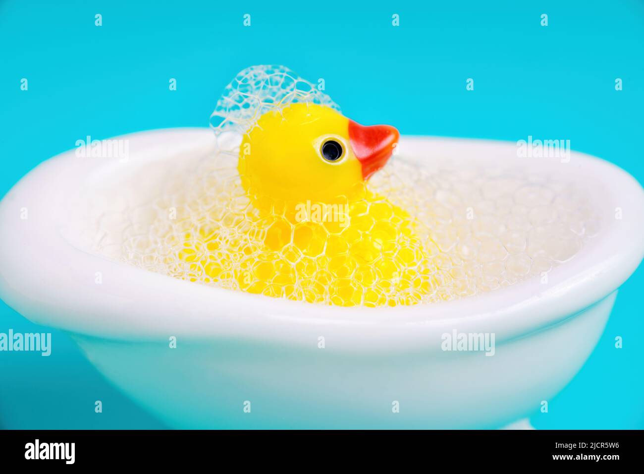 Close-up of a rubber duck in a miniature bathtub full of soap bubbles. Bath  time concept Stock Photo - Alamy