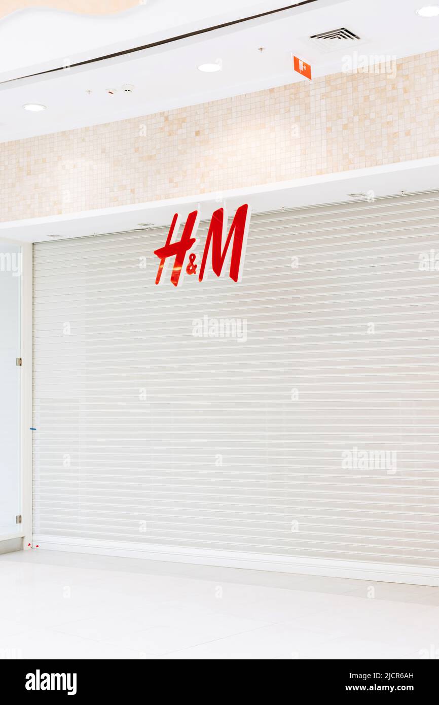 Saint Petersburg, Russia - 04.01.2022: Hennes and Mauritz or hm or H and M is closed in shopping mall of St. Petersburg. White roller shutter door or Stock Photo