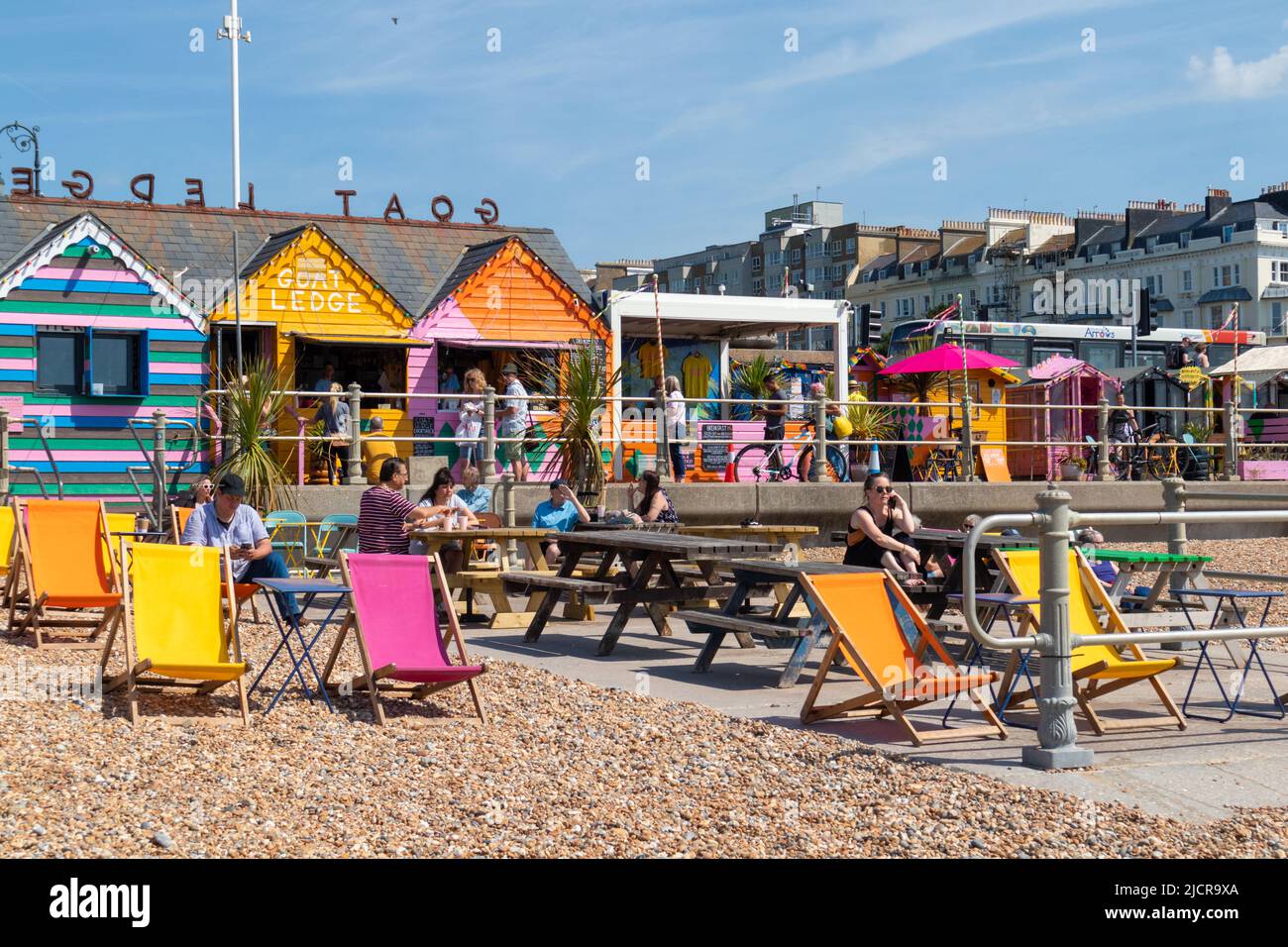 Hastings, East Sussex, UK. 15 Jun, 2022. UK Weather: Hot and sunny at the seaside town of Hastings in East Sussex as Brits enjoy the warm weather today along the seafront promenade. Colourful deckchairs on the beach at this cafe. Photo Credit: Paul Lawrenson /Alamy Live News Stock Photo