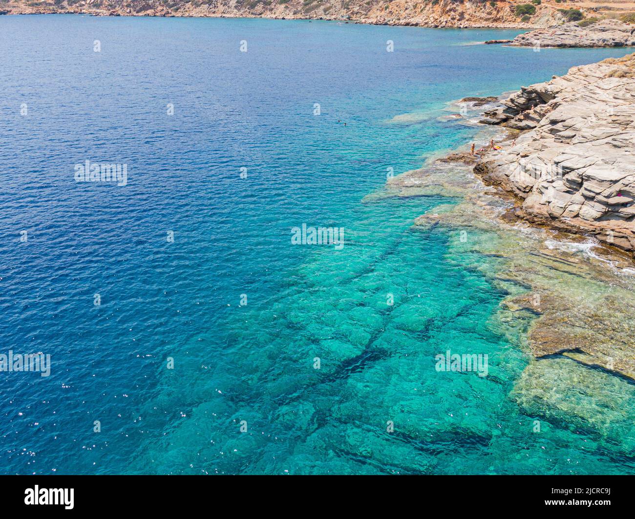 Azure water texture, transparent sea surface with a rocky bottom. Aerial view, natural blue background Stock Photo