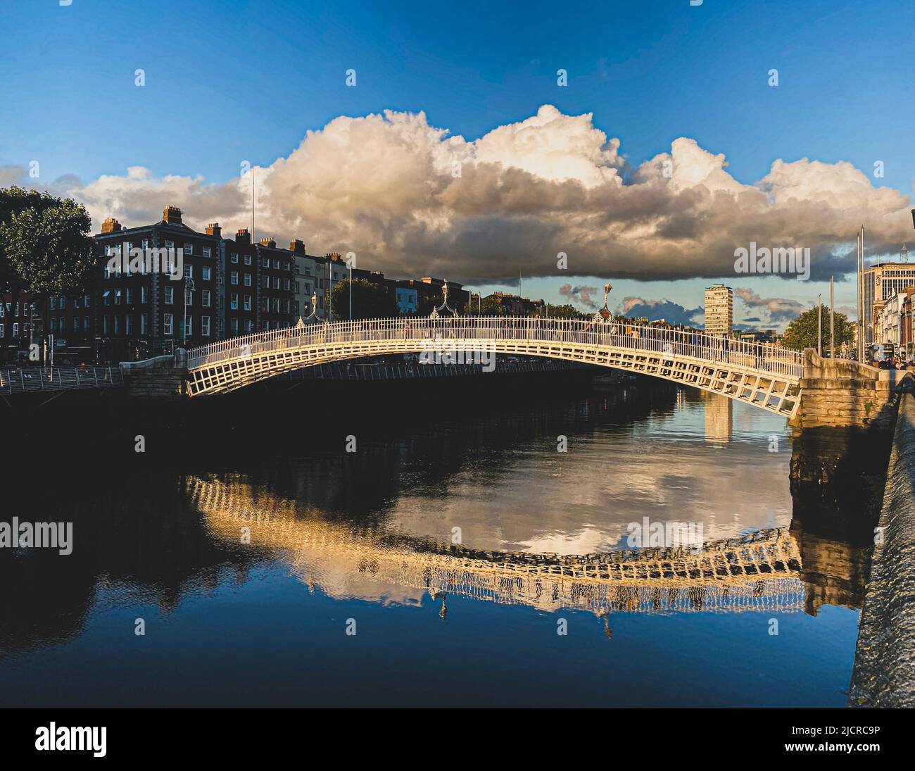 Ha penny bridge over the Liffey river at sunset, Dublin City, Ireland ...