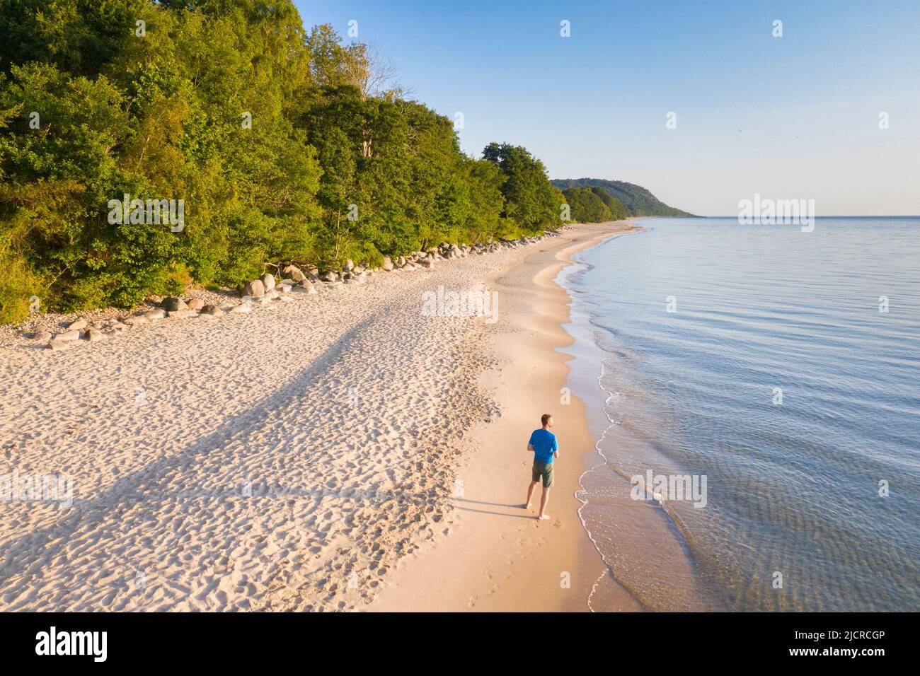 Man on sandy beach of the Baltic Sea near Knaebaeckshusen, Skane Province, Sweden Stock Photo