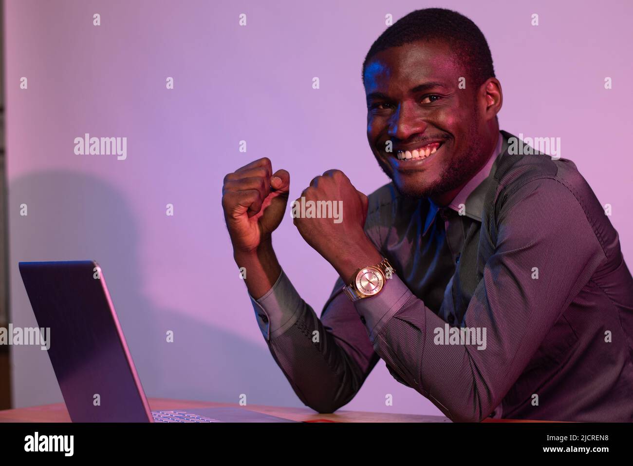 african man using his laptop rejoices Stock Photo