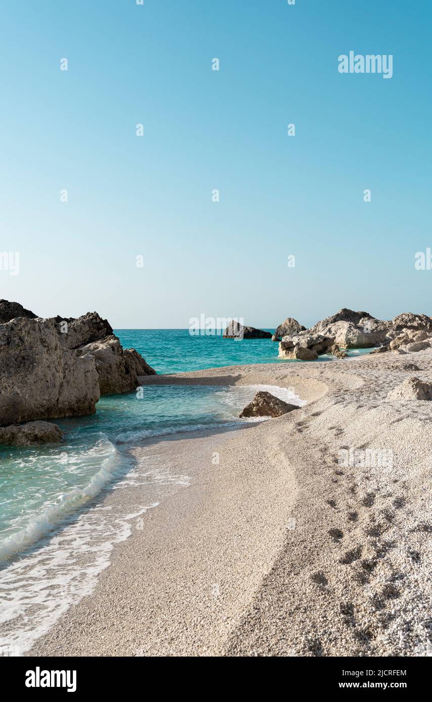 Beautiful summer Mediterranean pebble beach with small sea waves Stock Photo