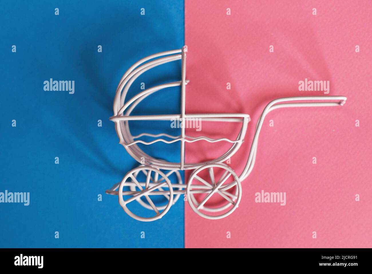 vintage baby stroller on a pink and blue background. Boy or girl question Stock Photo