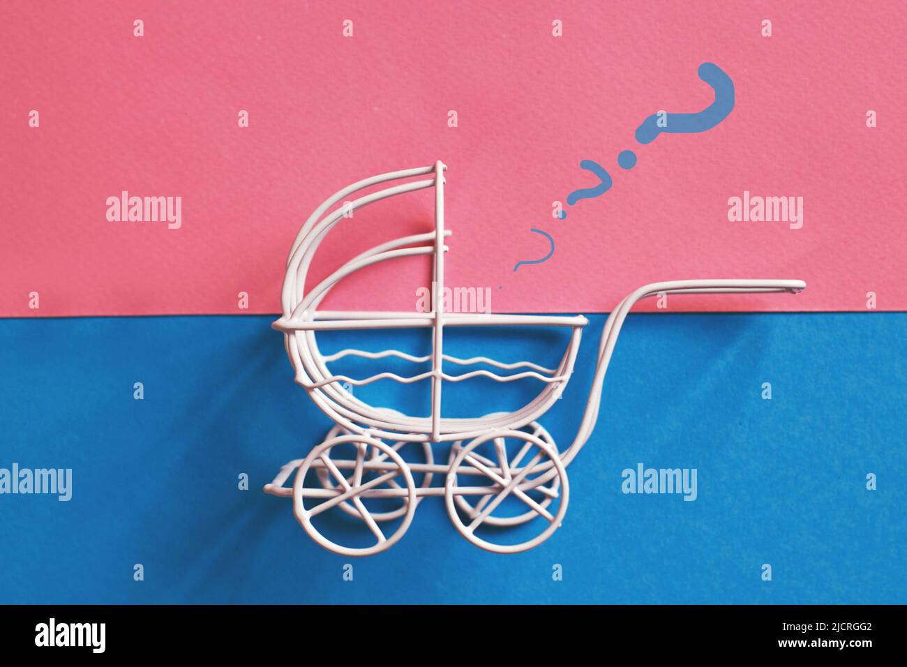 vintage baby stroller on a pink and blue background. Boy or girl question Stock Photo