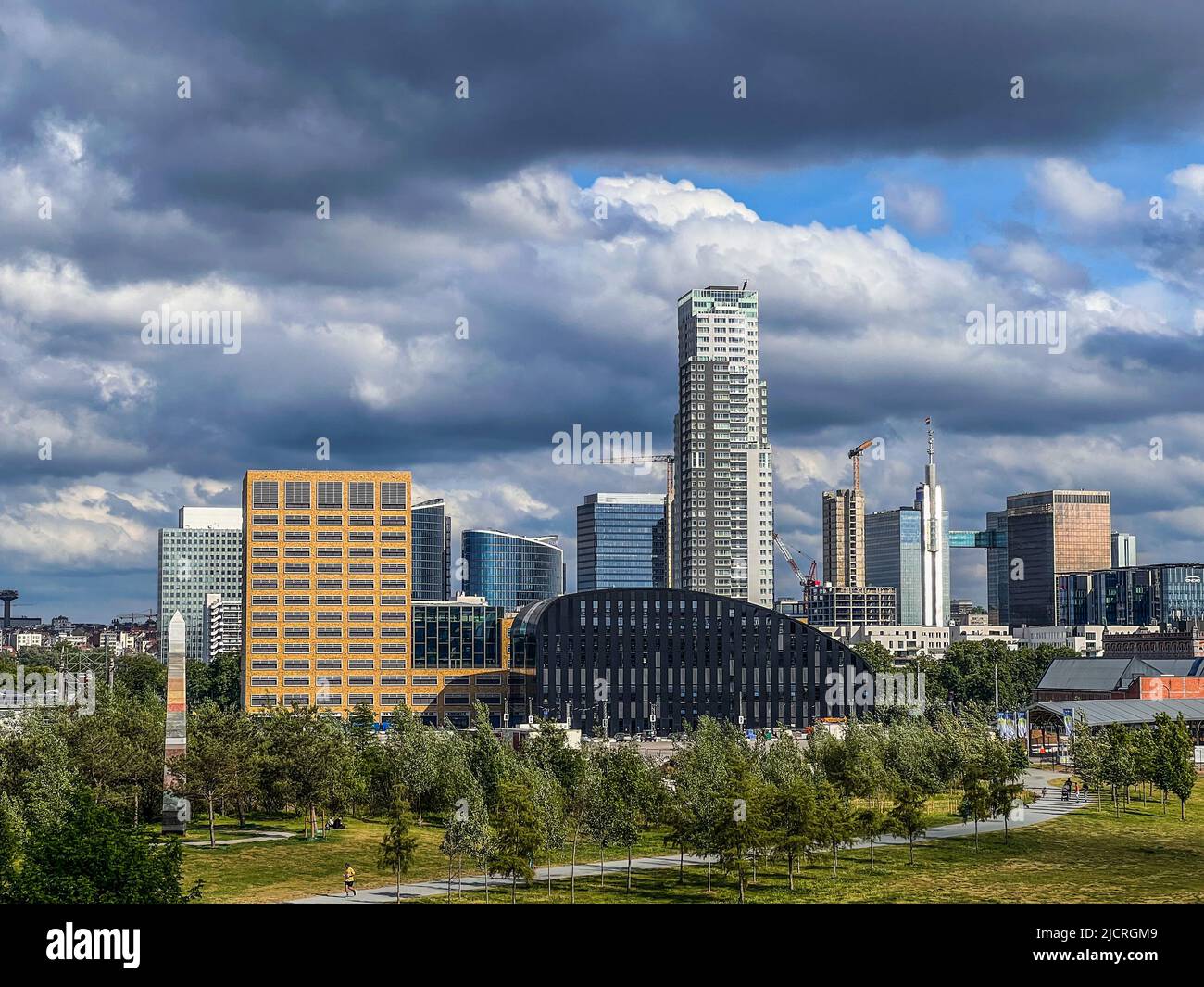 Brussels, Belgium - May 19, 2022: Cityscape of Brussels city,  skyscrapers in summer on a cloudy and sunny day with a dramatic sky. Green park in the Stock Photo