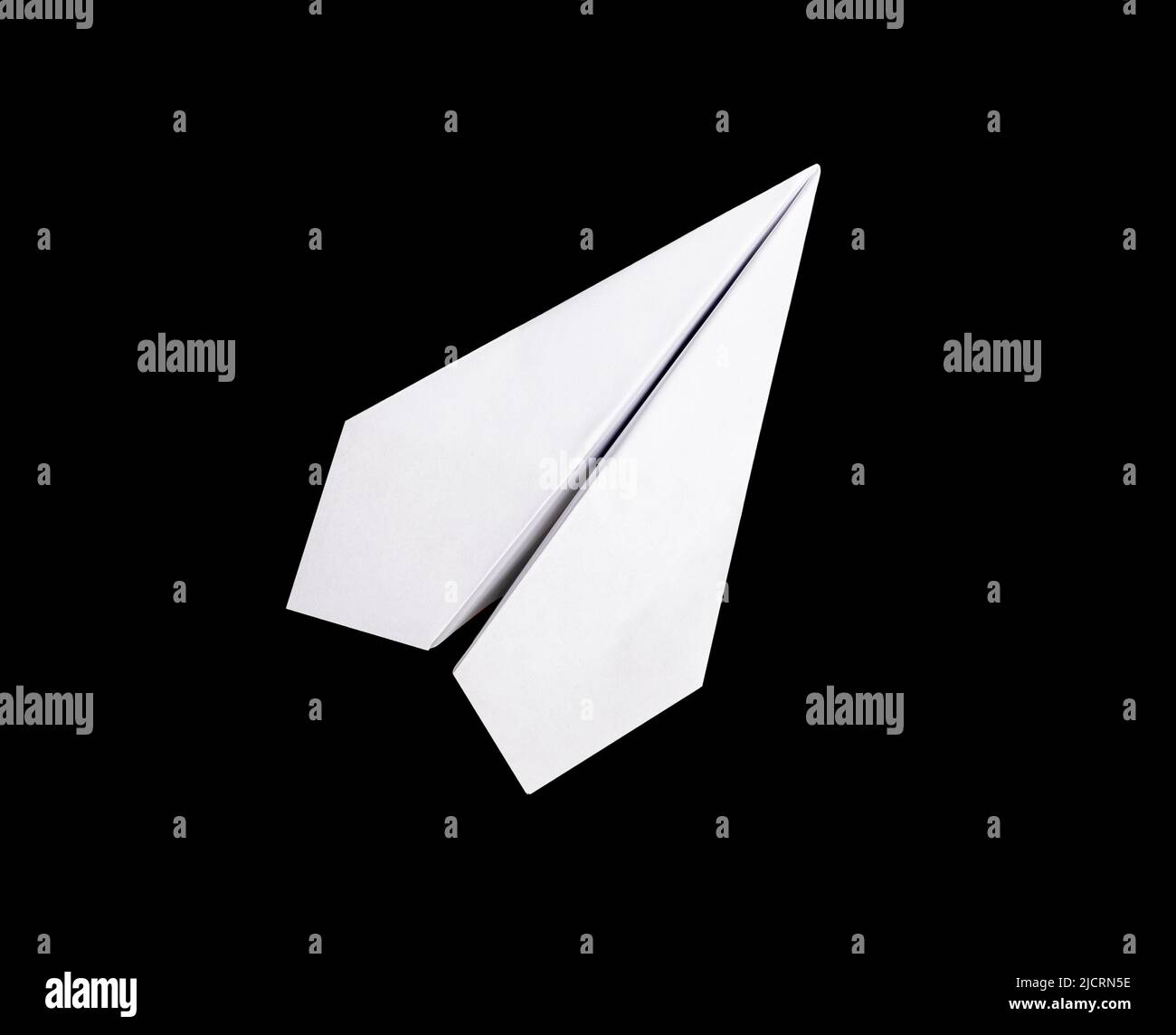 White origami plane on black background. Paper folding art. Handmade object. High quality photo Stock Photo