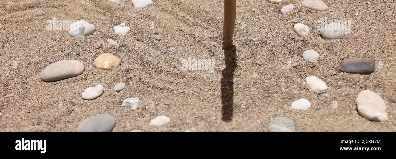 Sundial made of stones on sand closeup background Stock Photo