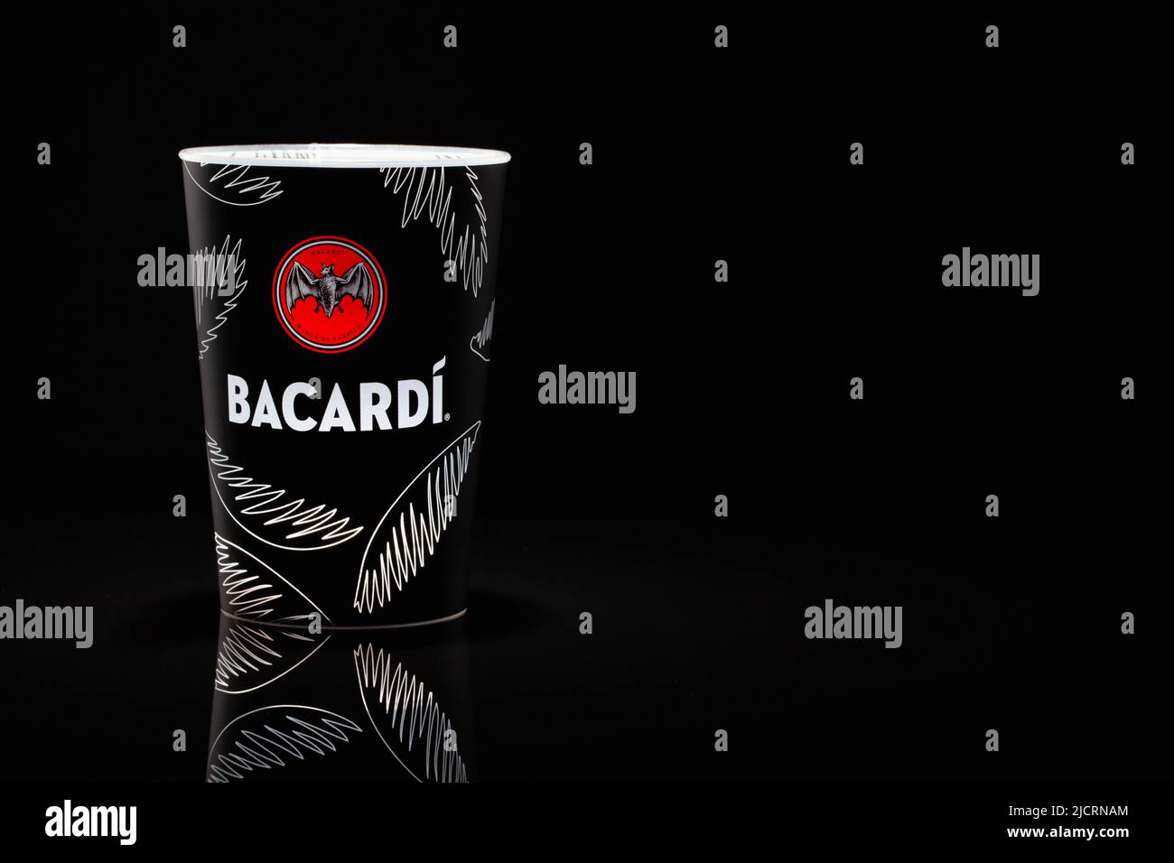 Prague, Czech Republic - 22, March 2022: Bacardi plastic cup for mixed drinks on the glass table. Stock Photo