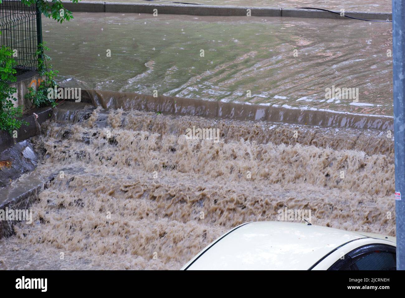 Road covered with dirty flood water after heavy rain Stock Photo