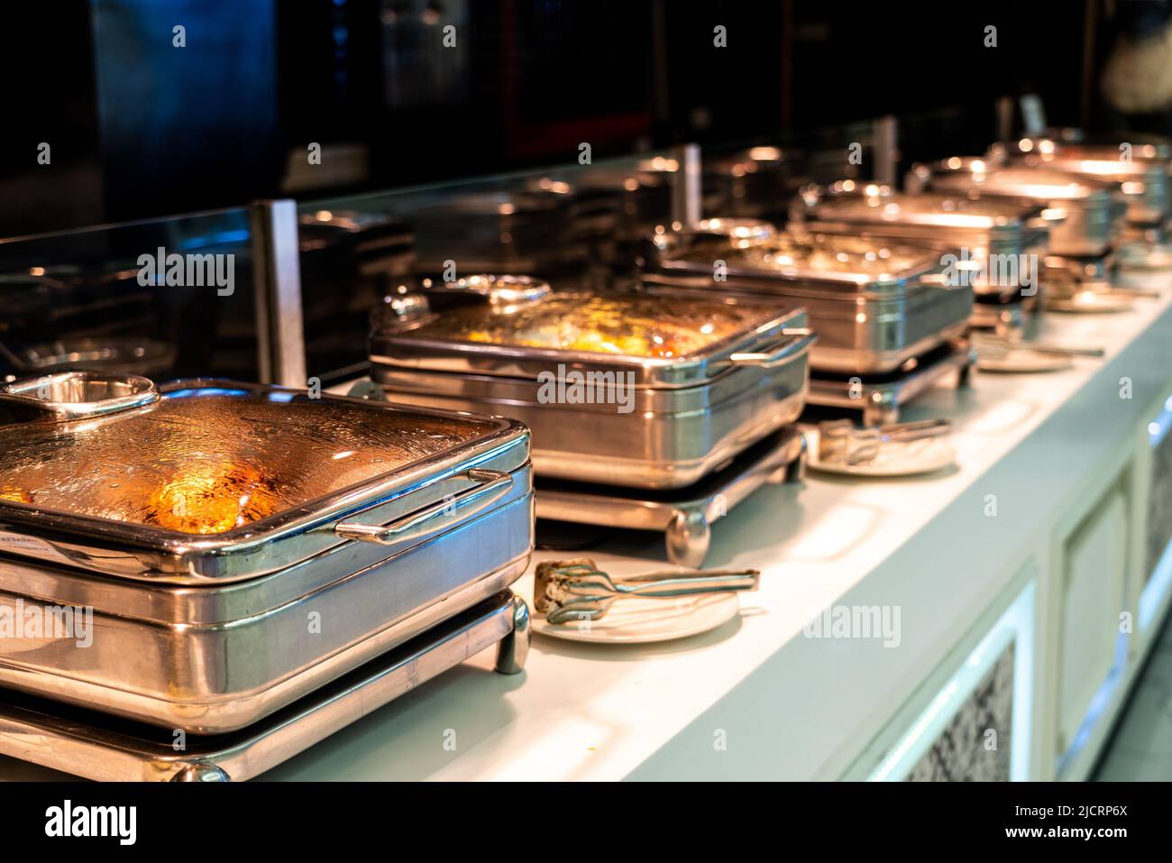 Catering buffet food with heated trays ready for service in hotel