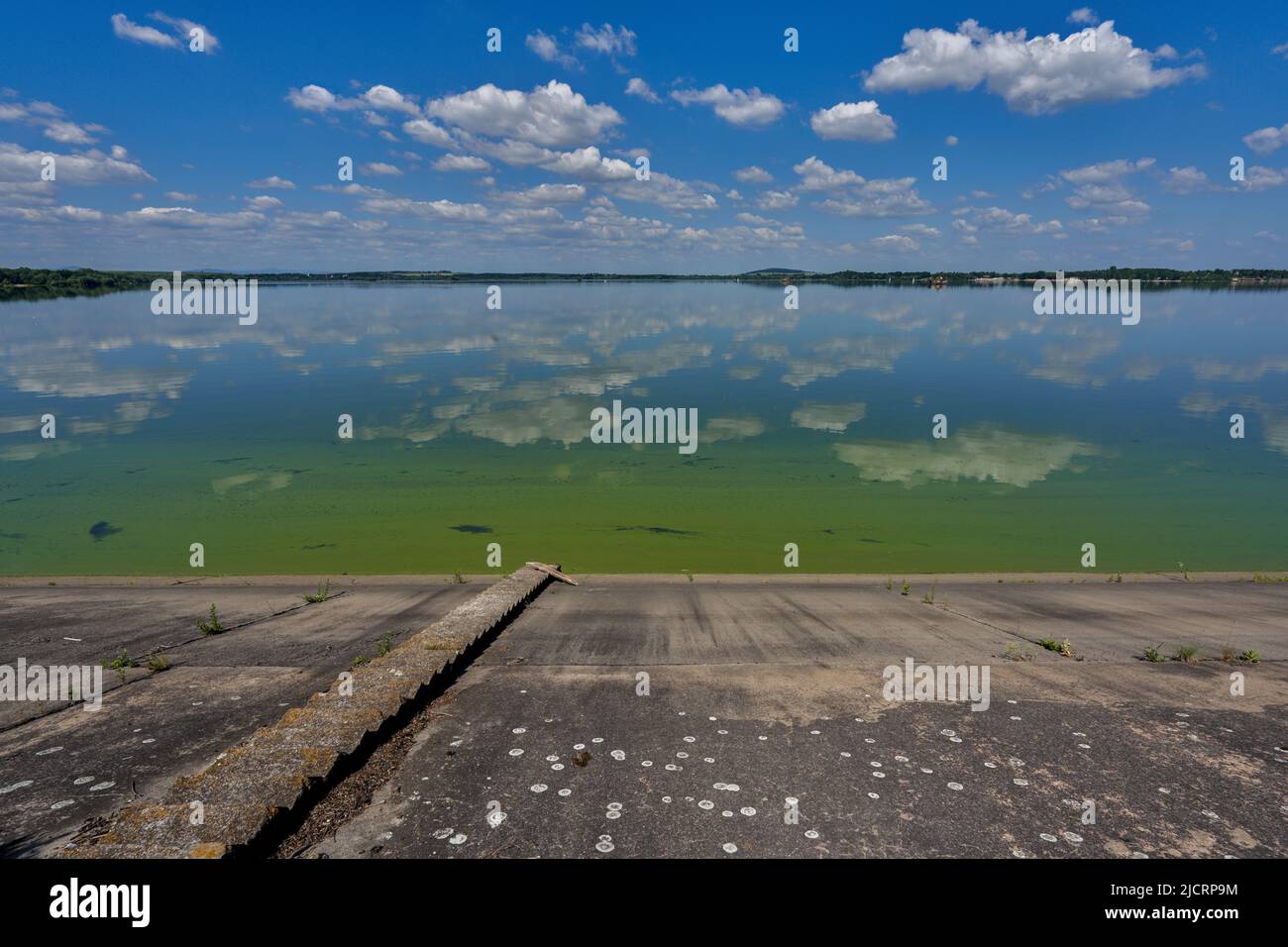 Blue sky with white clouds reflecting on the water Stock Photo