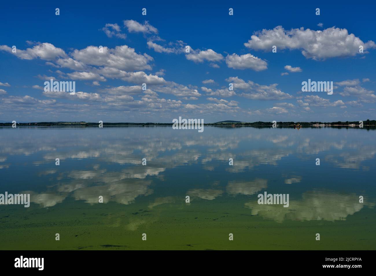 Blue sky with white clouds reflecting on the water Stock Photo - Alamy