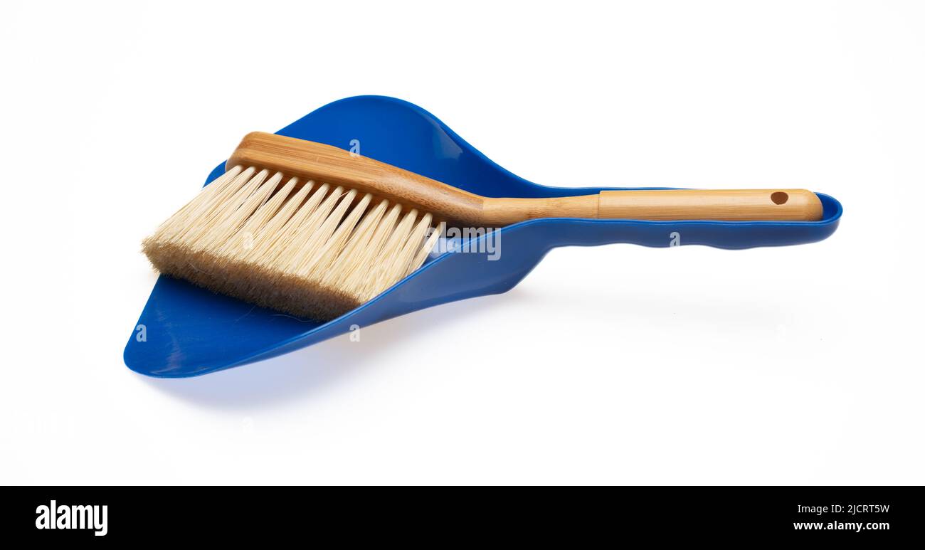 Wooden small broom and blue dustpan isolated cutout on white background ...