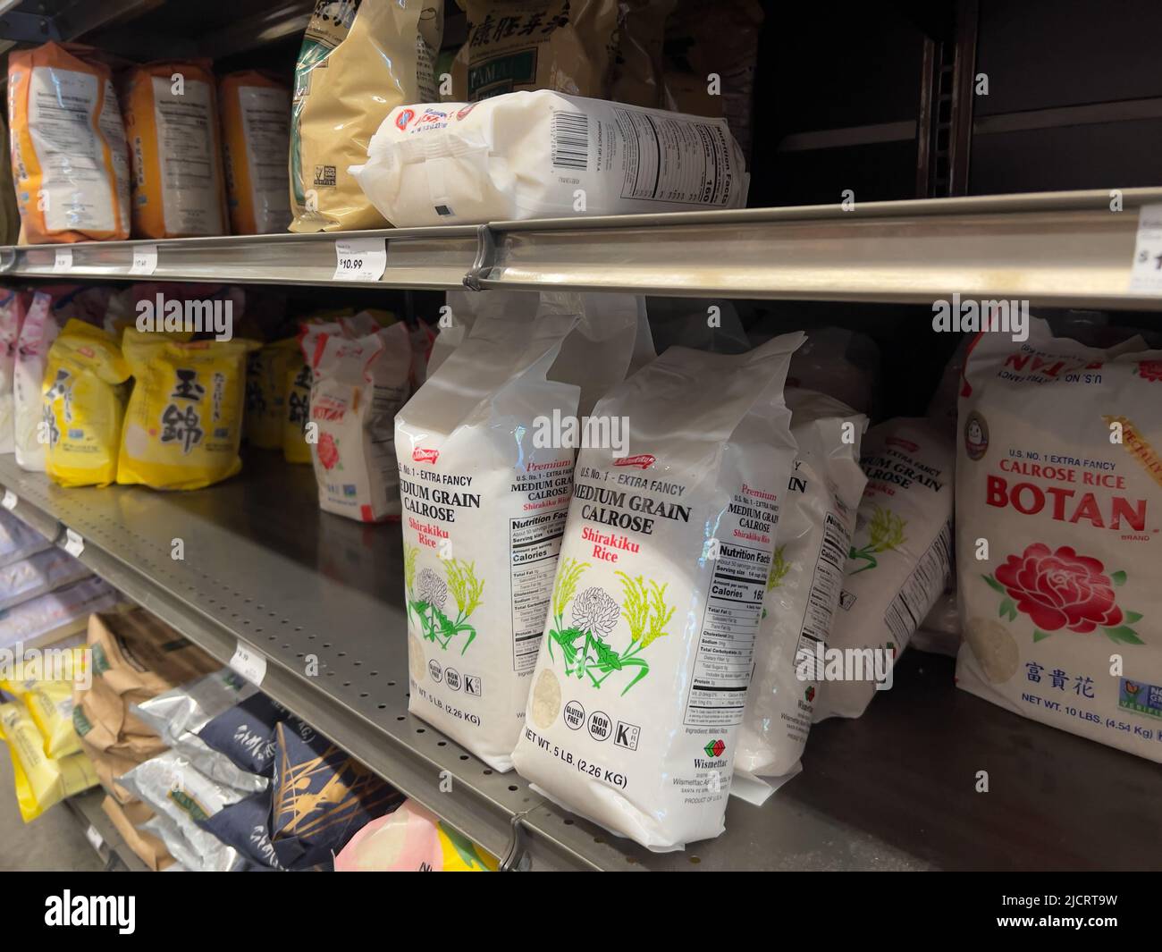 Mill Creek, WA USA - circa May 2022: Angled view of a variety of calrose rice bags for sale inside a Town and Country grocery store. Stock Photo
