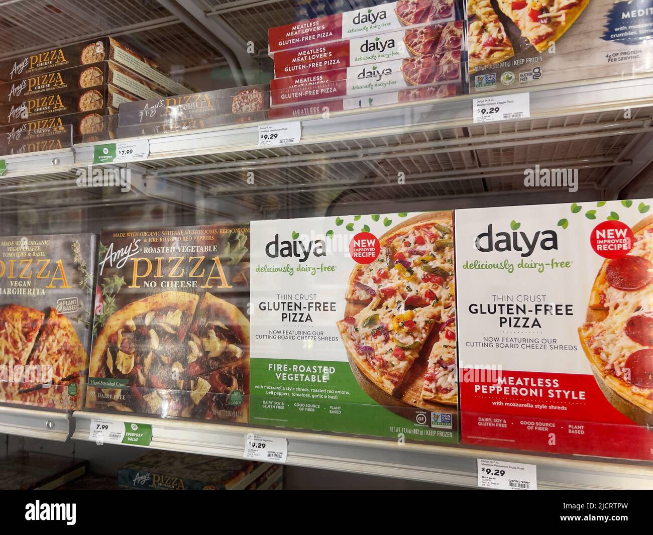 Mill Creek, WA USA - circa May 2022: Angled view of a variety of frozen pizzas for sale inside the freezer section of a Town and Country Market. Stock Photo