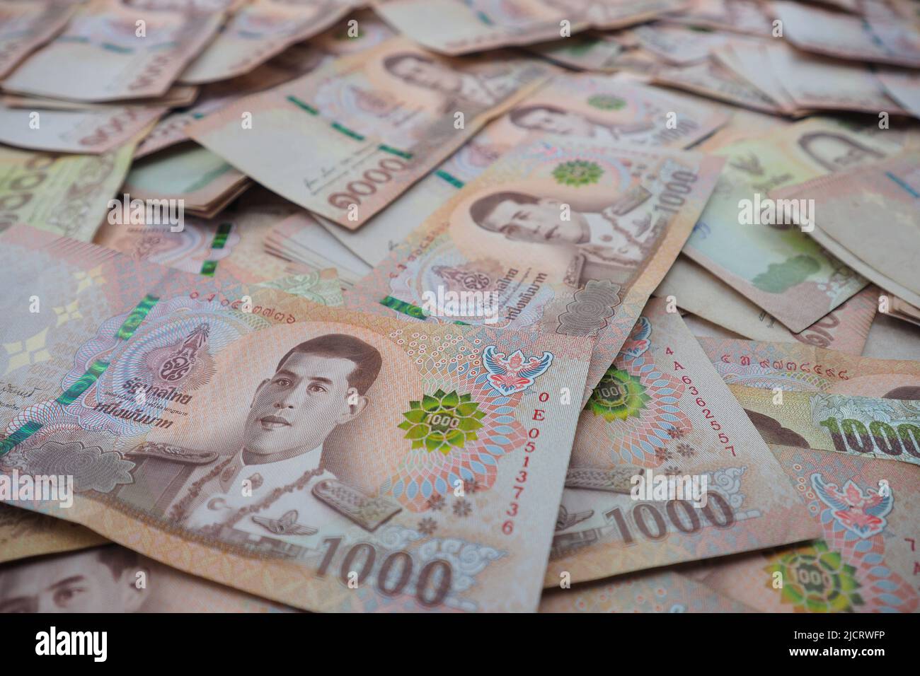 Close-up a pile of one thousand Thai Baht (THB) banknotes of Thailand. Cash of thousand baht bills, Background image with high resolution. Stock Photo