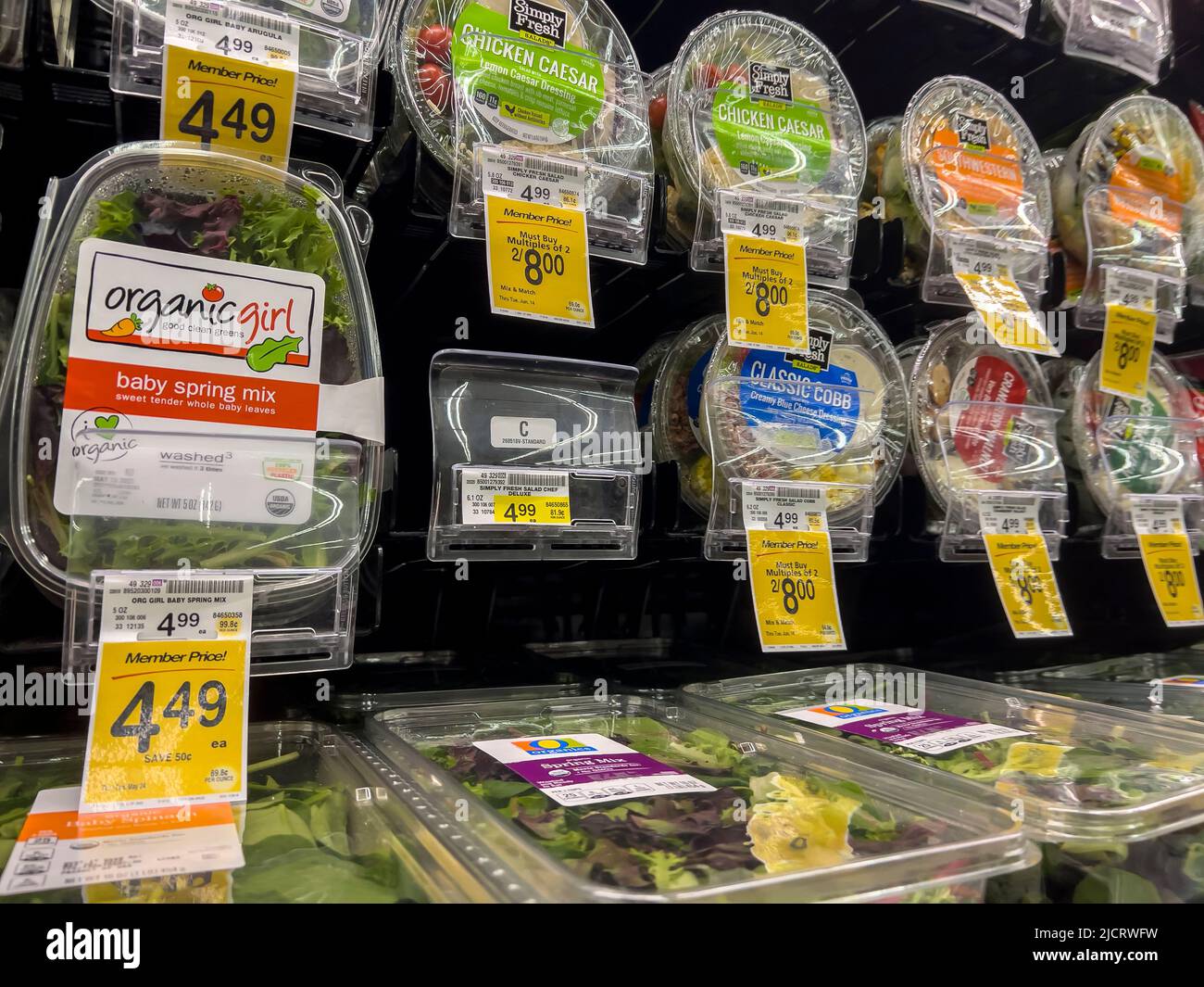 Mill Creek, WA USA - circa May 2022: Angled view of a variety of salad greens and pre-made salads for sale inside a Safeway grocery store. Stock Photo