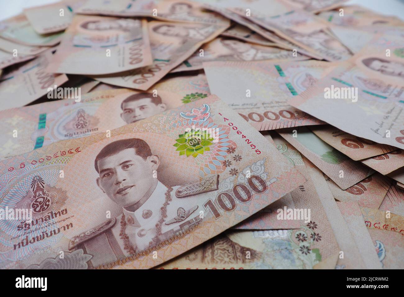 Close-up a pile of one thousand Thai Baht (THB) banknotes of Thailand. Cash of thousand baht bills, Background image with high resolution. Stock Photo