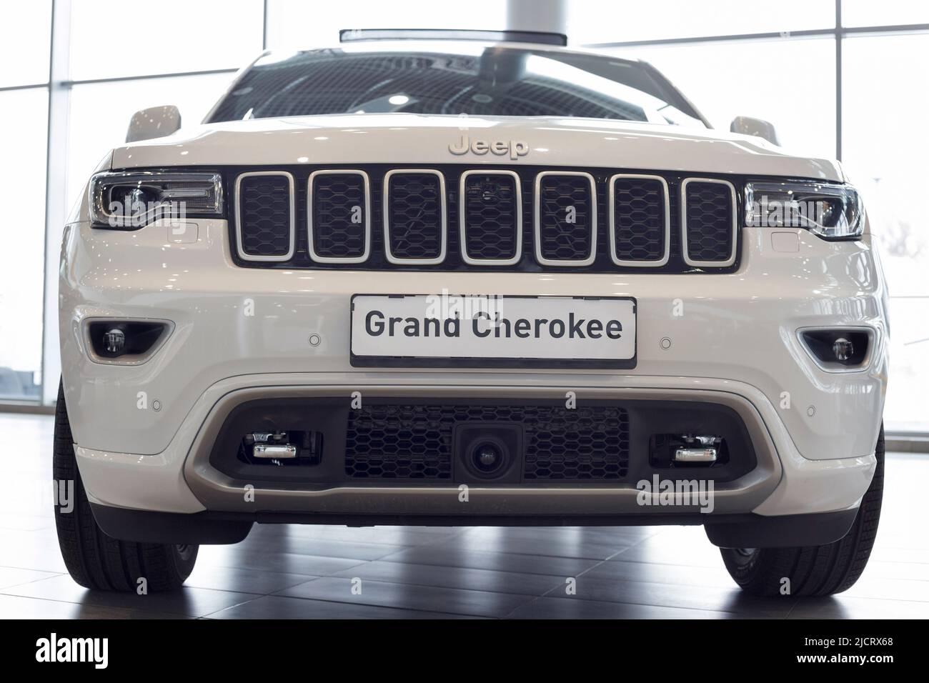 Russia, Izhevsk - March 4, 2022: Jeep showroom. New modern Grand Cherokee in dealer showroom. Front view. Off-road vehicles. Alliance Stellantis. Stock Photo