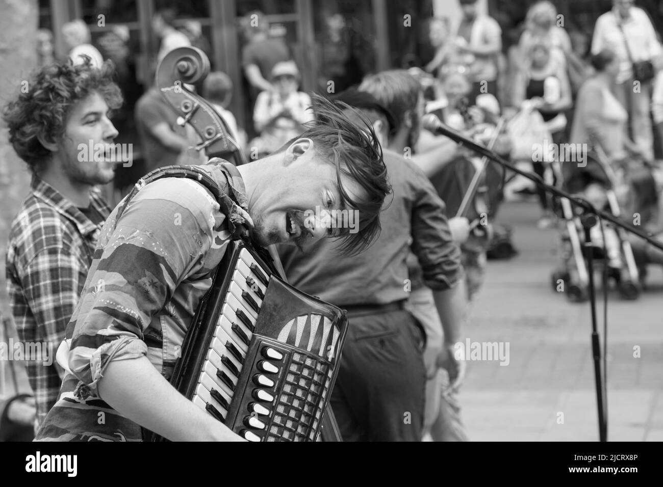 Hyde Family Jam folk band playing on a York city street, with a close-up of the accordion player, North Yorkshire, England, UK. Stock Photo