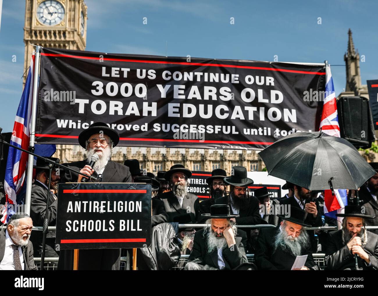 London, UK. 15th June, 2022. Rabbi Schlesinger speaks. A delegation of Jewish Rabbies, accompanied by Haredi orthodox members of the Jewish community from the UK, have assembled outside Parliament to protest against the Schools Bill 2022, which is going through the House of Lords. The group perceive the Schools Bill as a threat to fundamental aspects of Jewish practice and religious principles in religious schools. Credit: Imageplotter/Alamy Live News Stock Photo