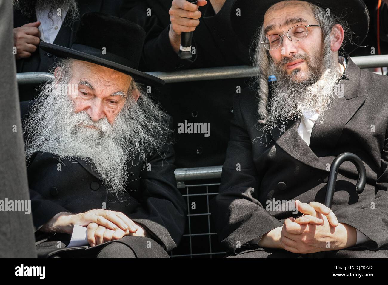 London, UK. 15th June, 2022. Haredi community membersk listens to the ...