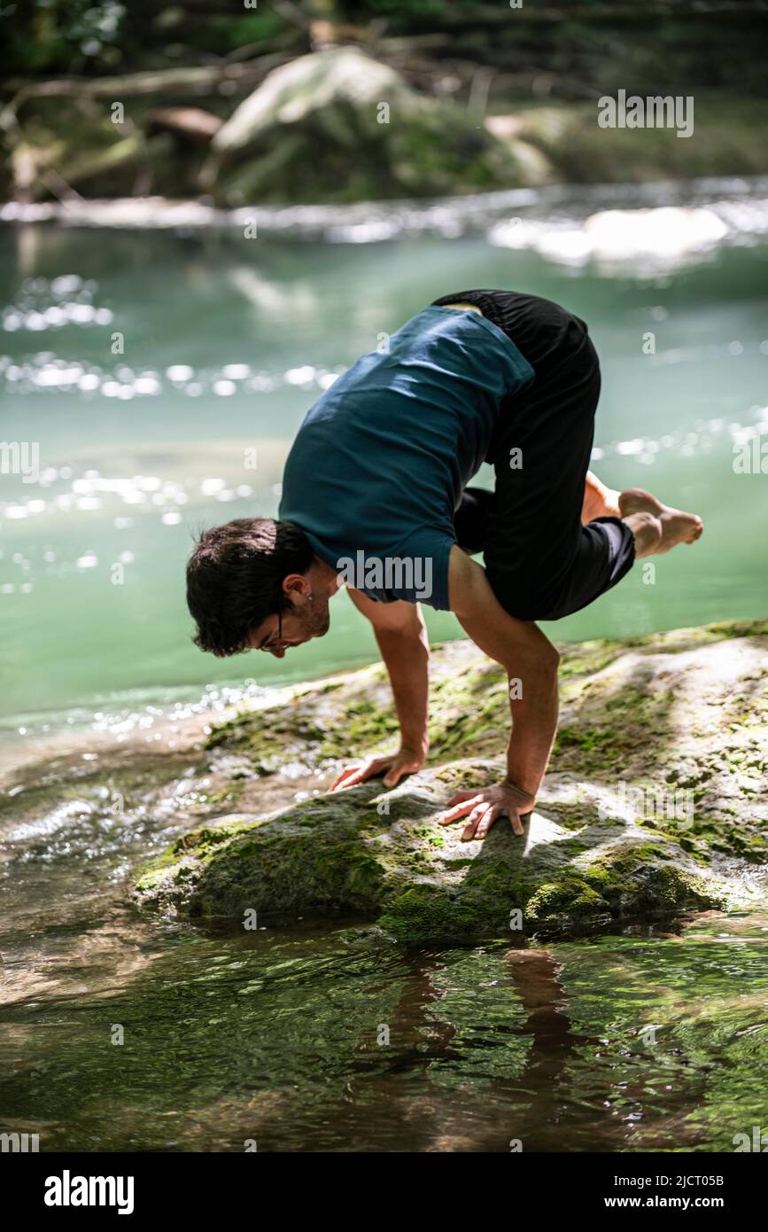 boy doing yoga by the river Stock Photo