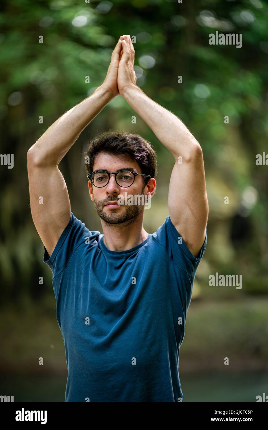 boy doing yoga by the river Stock Photo