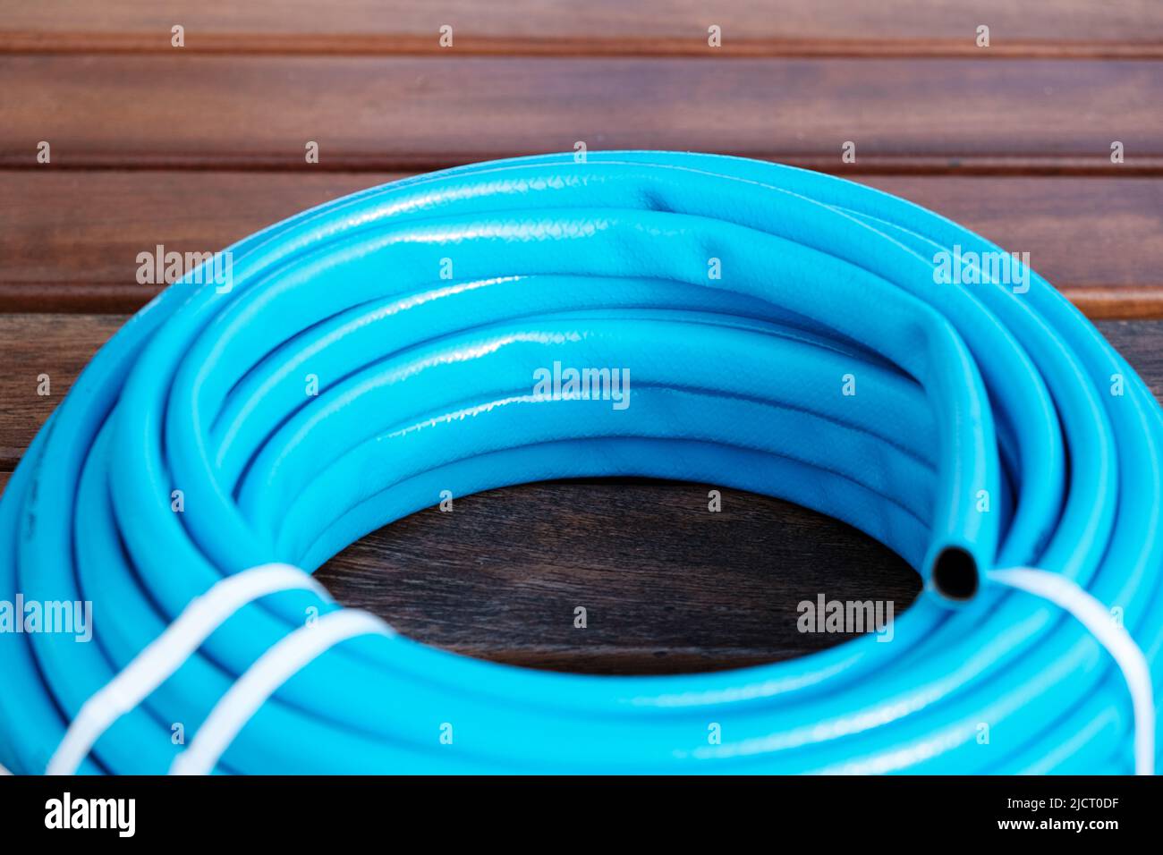 Detail of the rubber material of a new blue hose, built with recycled material. Stock Photo