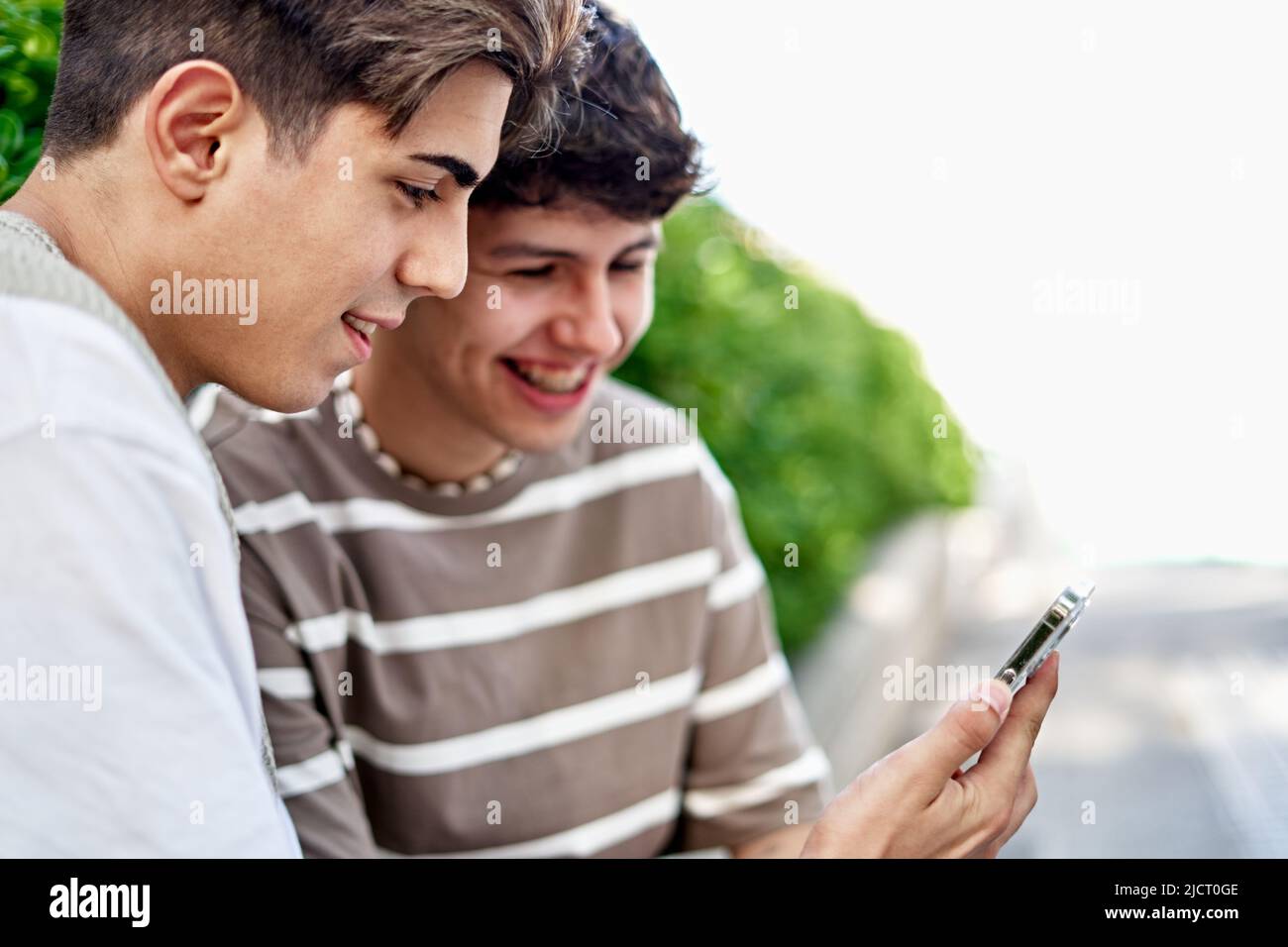 Man Shows His Boyfriend A Video On His Phone Stock Photo