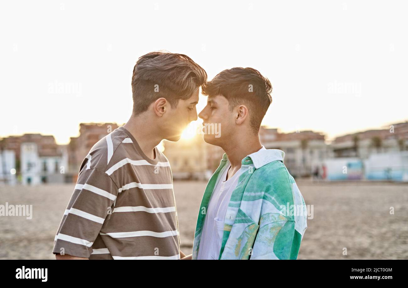 Intimate moment of a gay couple in the beach Stock Photo