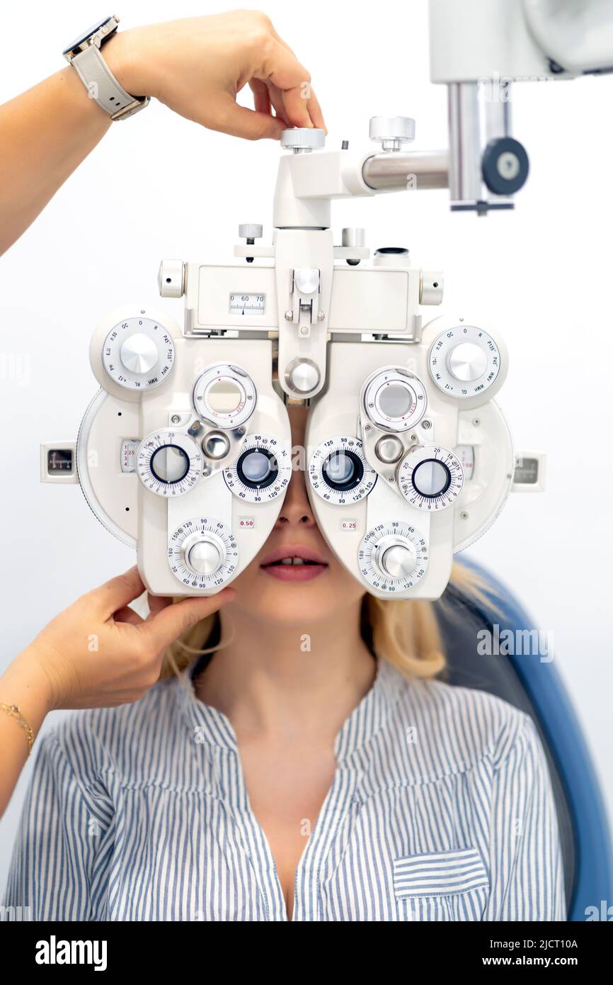 blonde girl checking her eyesight at the ophthalmologist Stock Photo