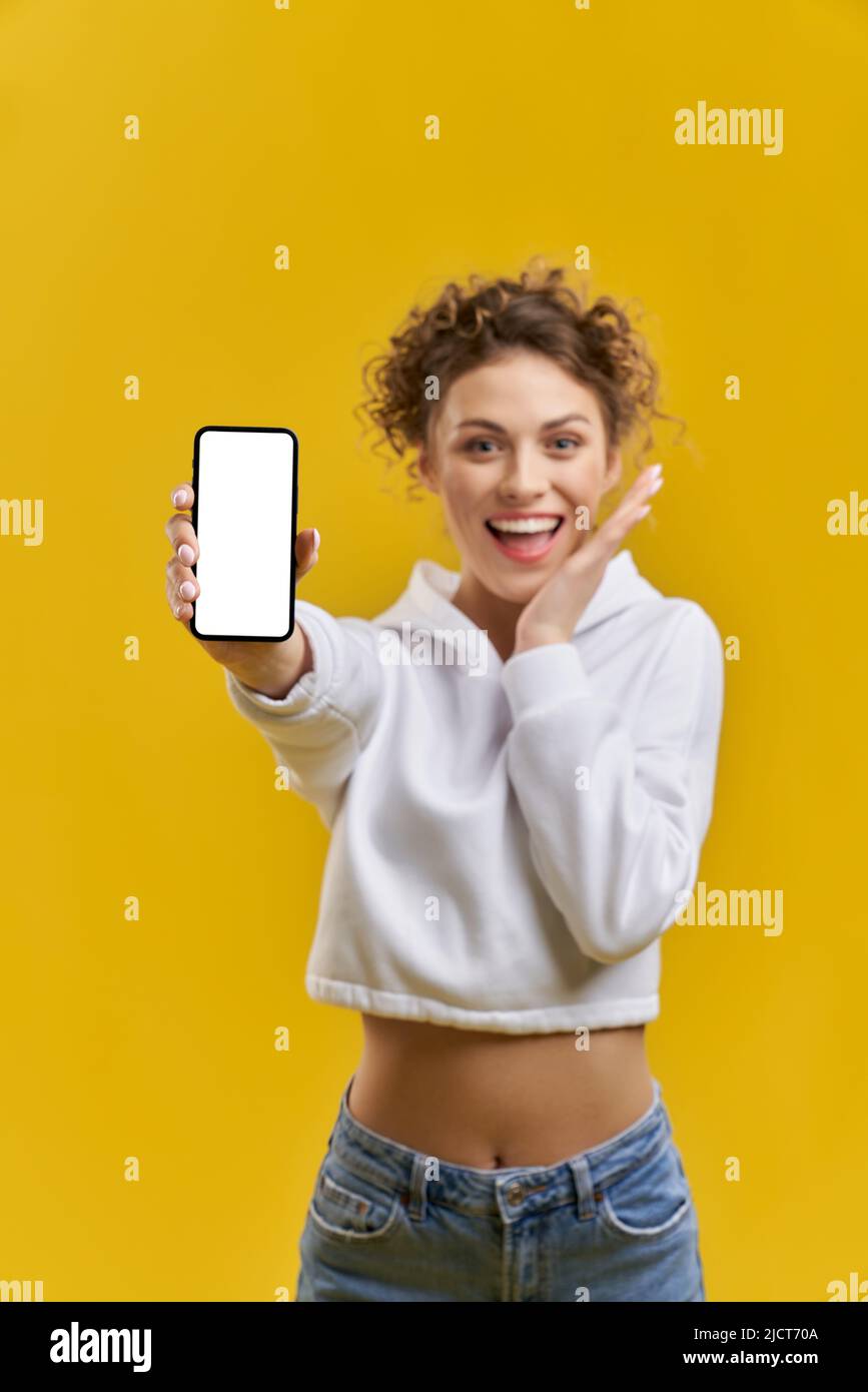 Happy blurred girl showing white screen of smartphone inside. Close up