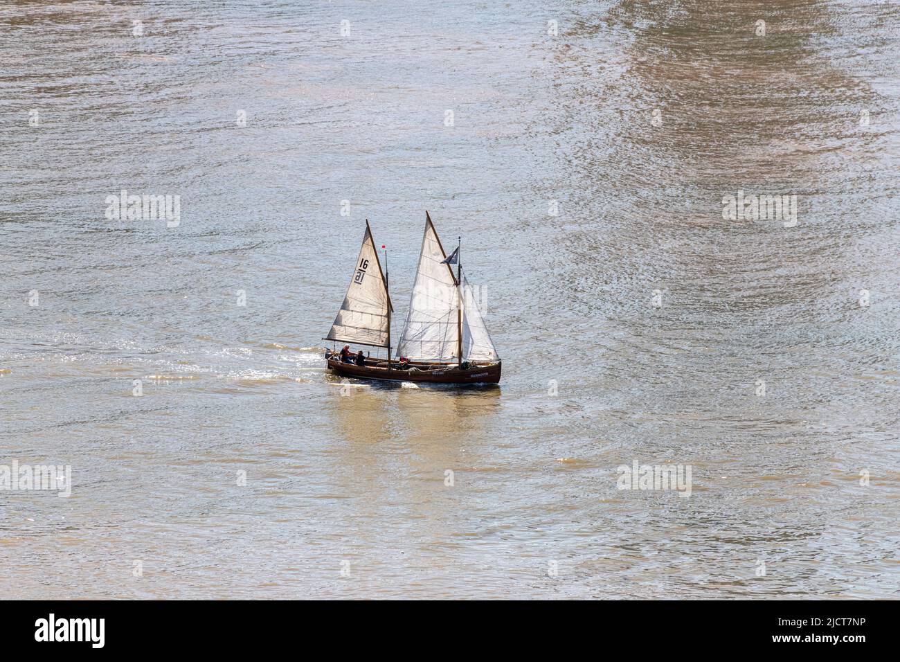 A Sailing cutter makes its way up the River Thames at Greenwich in East London. Stock Photo