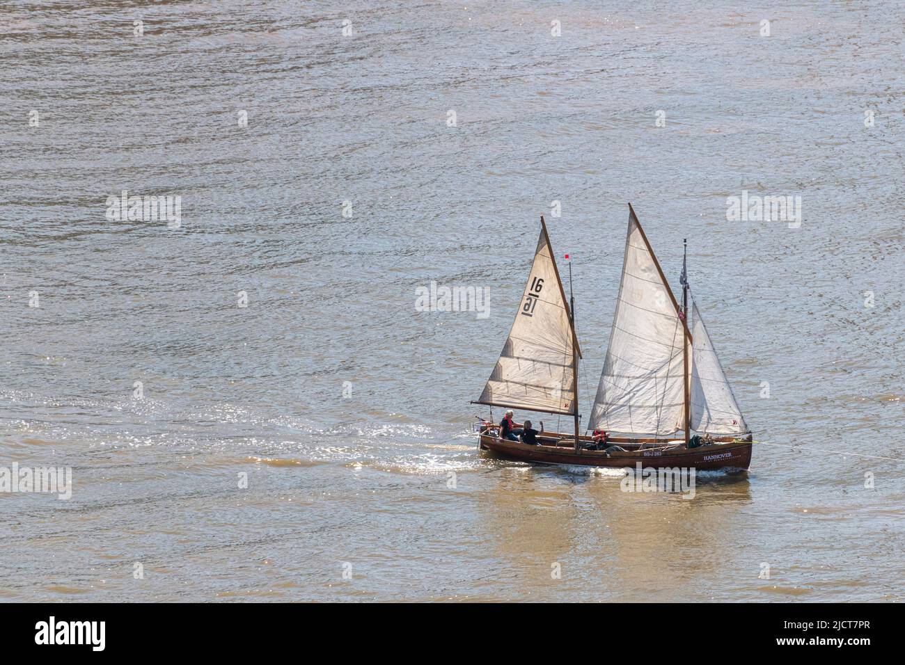 A Sailing cutter makes its way up the River Thames at Greenwich in East London. Stock Photo