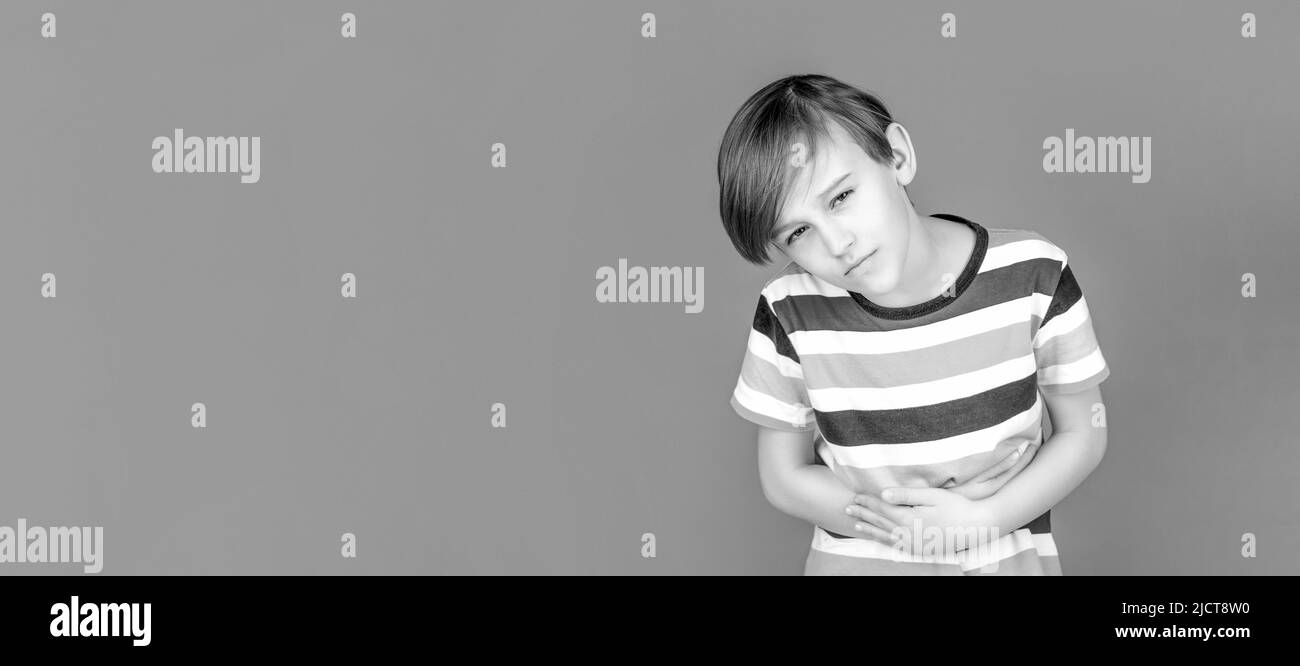 Stomach pain. Teen boy with stomachache. Child having terrible pain in