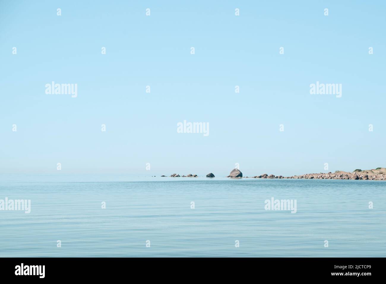 Seascape. Blue sky. Stones in the sea. High quality photo Stock Photo