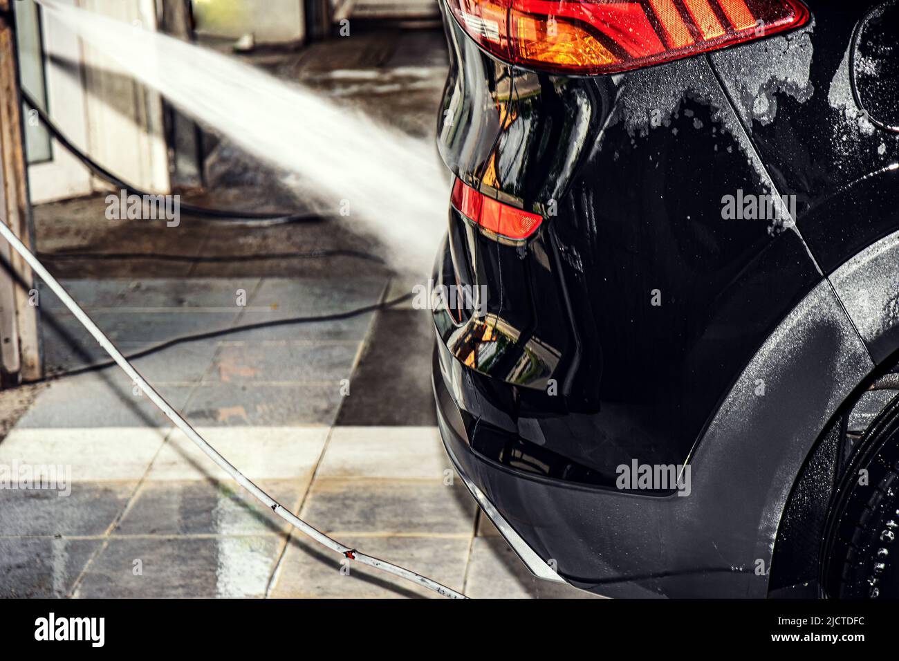 woman washing car with pressure washer at self-service car wash station,  selective focus Stock Photo - Alamy