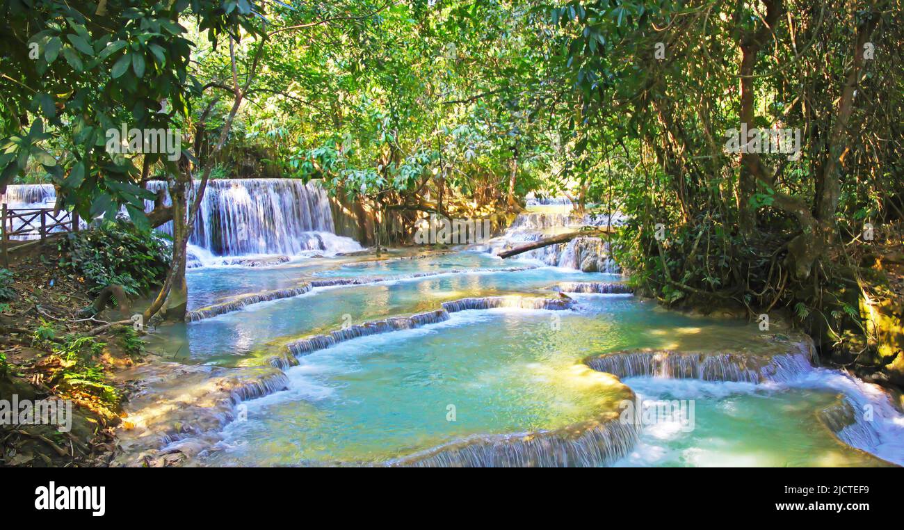 Beautiful idyllic lonely tropical waterfall staircase cascade, turquoise blue secluded water plunge pools, green forest jungle - Kuang Si, Luang Praba Stock Photo