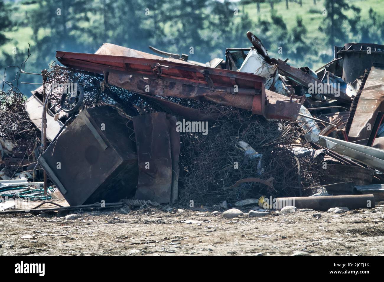 A mountain of scrap metal in the mountains. Pollution of nature by