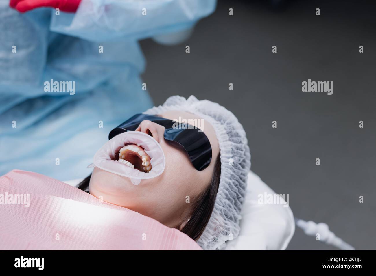Woman's face with glasses at the dentist. Preparation for treatment. High quality photo Stock Photo