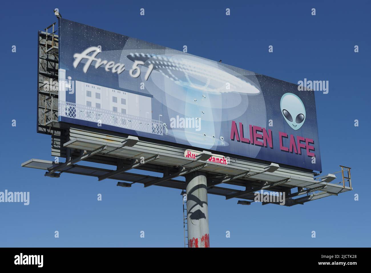 Amargosa Valley, Nevada, USA - February 26, 2022: image of a tall billboard indicationg a cafe at Area 51 Alien Center shown on a sunny day with blue Stock Photo